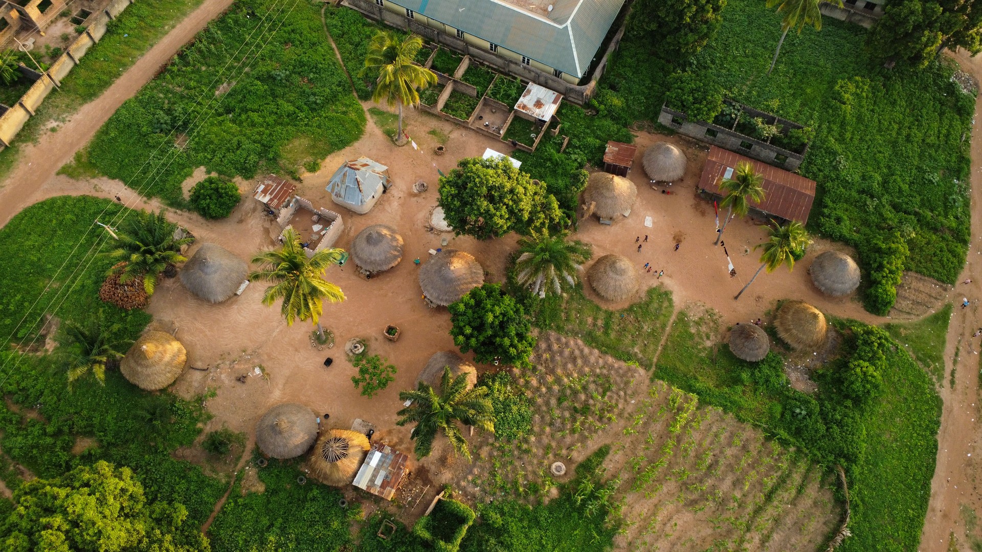 Serene Aerial View of a Traditional African Village Featuring Thatched Huts and Lush Greenery